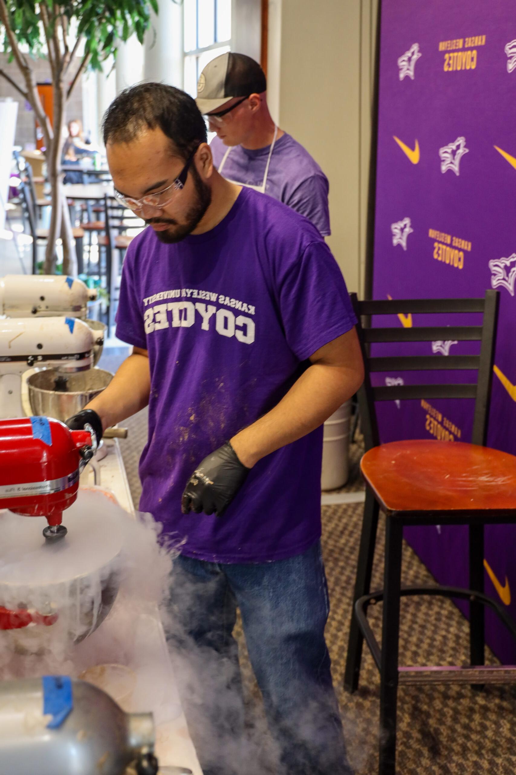 Man in t-shirt working with steaming liquid nitrogen