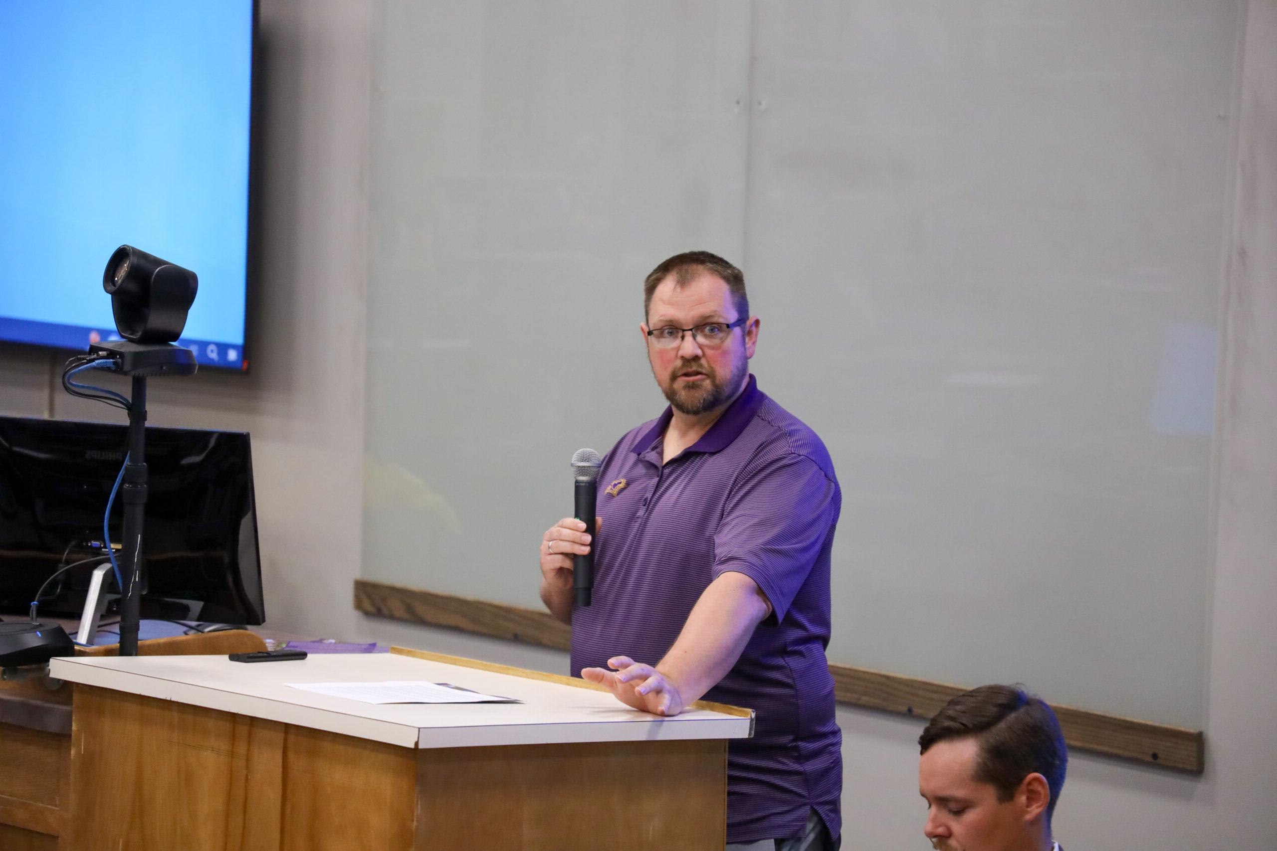 Man speaking in front of classroom