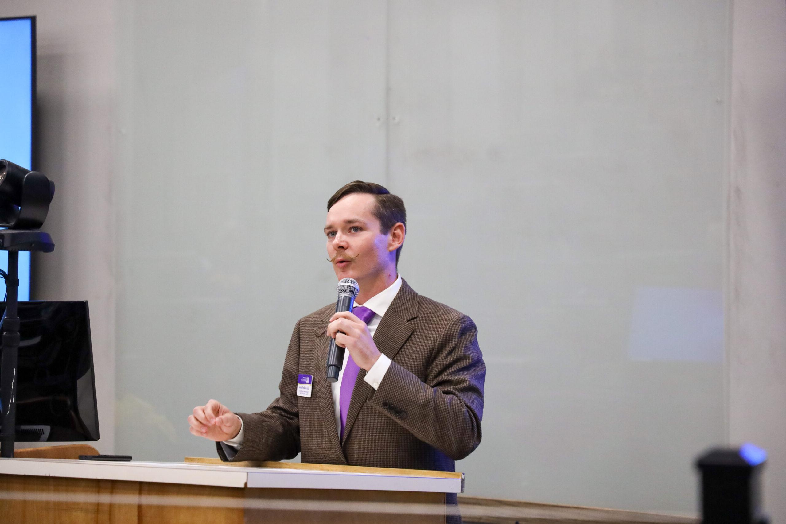 Man speaking in front of classroom