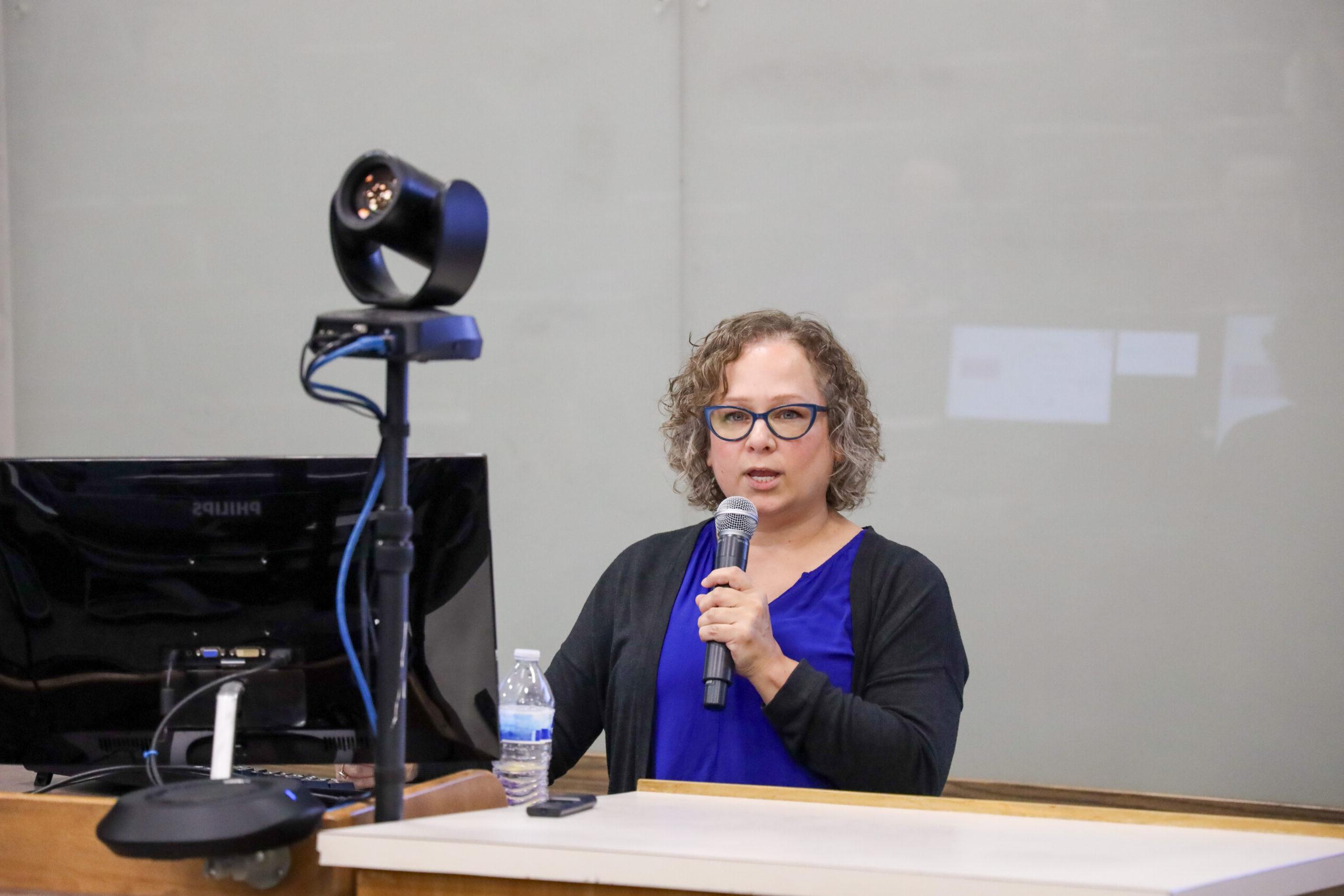 Woman speaking in front of classroom