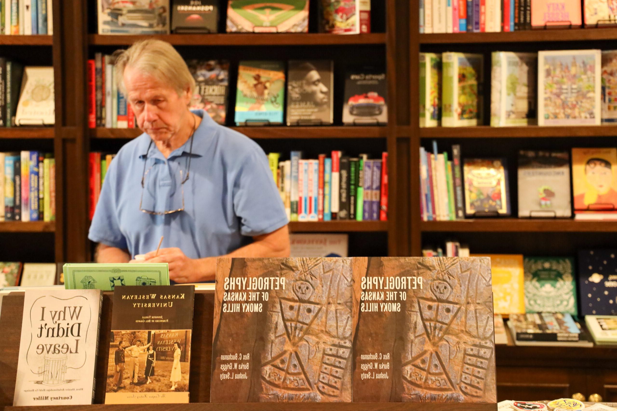 Man standing behind bookstore display