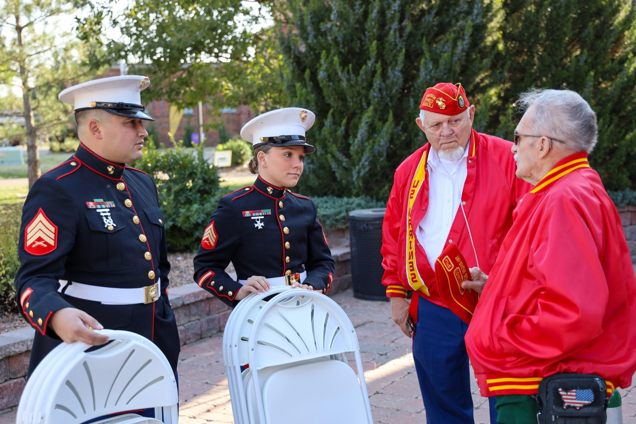 Individuals in uniform at Veterans Ceremony with speaker